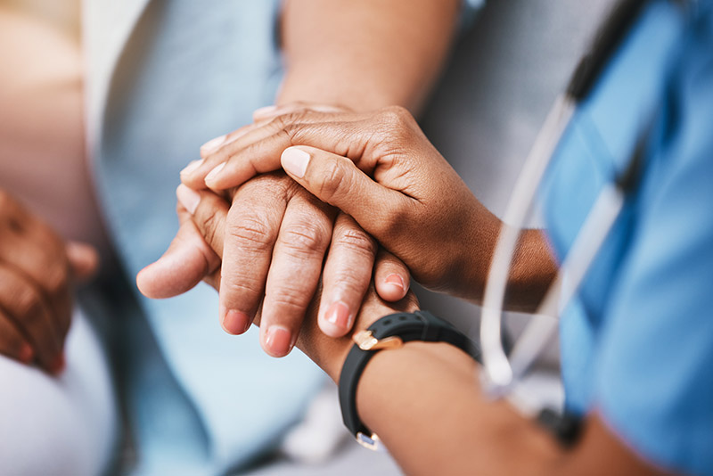 Nurse holding the patient's hand