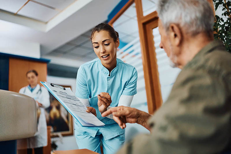 Doctor in waiting area working with patients to improve community health outcomes